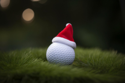 festivelooking-golf-ball-tee-with-santa-claus-hat-top-holiday-season-golf-course-background.jpg