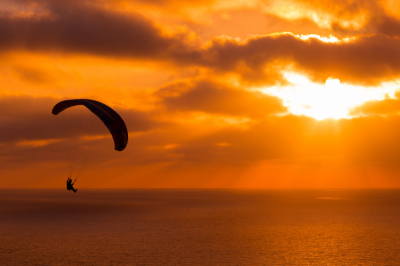paragliding-sunset-with-amazing-cloudy-sky-sun-shining-through-clouds.jpg