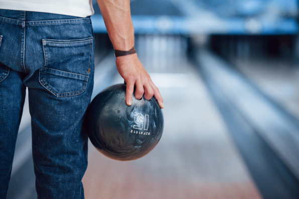 artificial-lighting-rear-particle-view-man-casual-clothes-playing-bowling-club.jpg