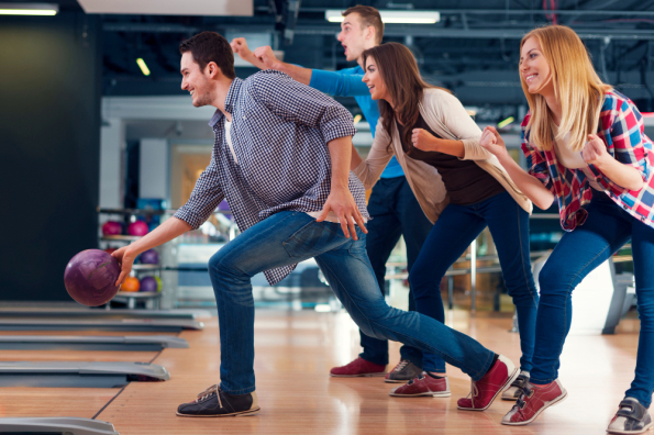 friends-cheering-their-friend-while-throwing-bowling-ball.jpg